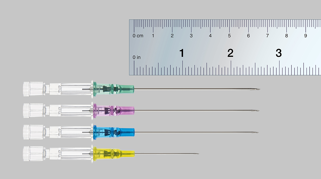 Introcan Safety Deep Access Longer Length Catheters lined up next to a ruler to show length of needles.